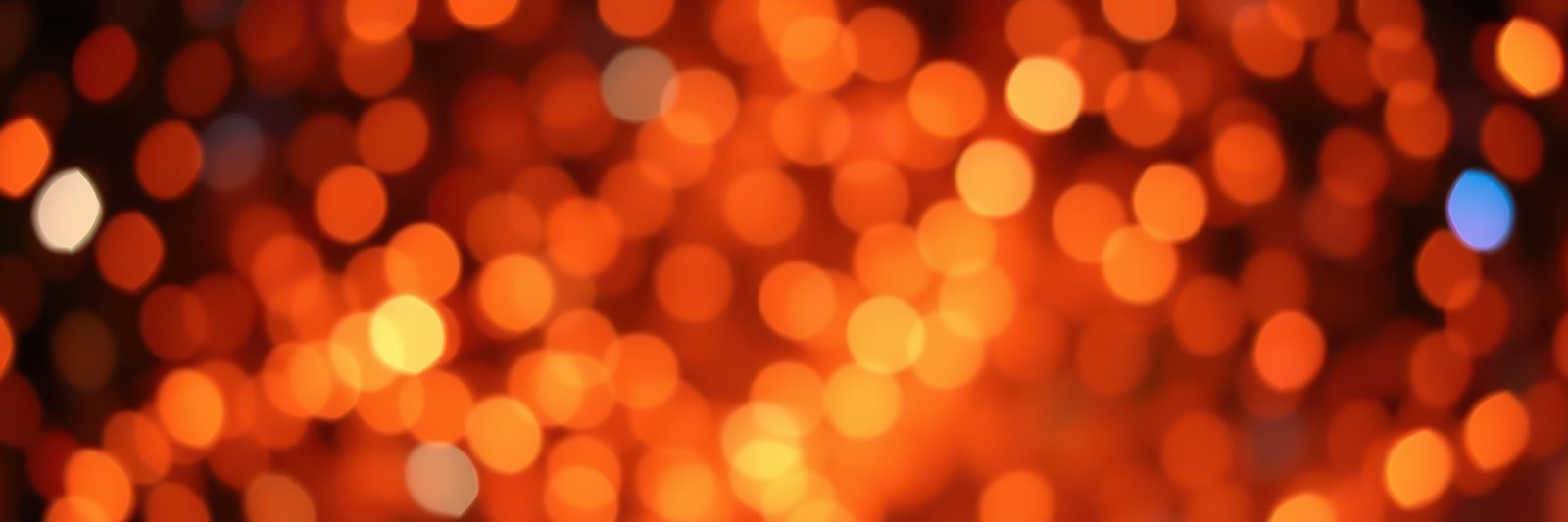 Bright orange bokeh lights create an enchanting atmosphere for a celebration or event